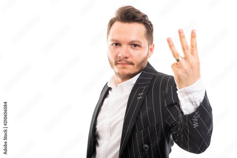 Portrait of business man showing number three. Portrait of business man showing number three.