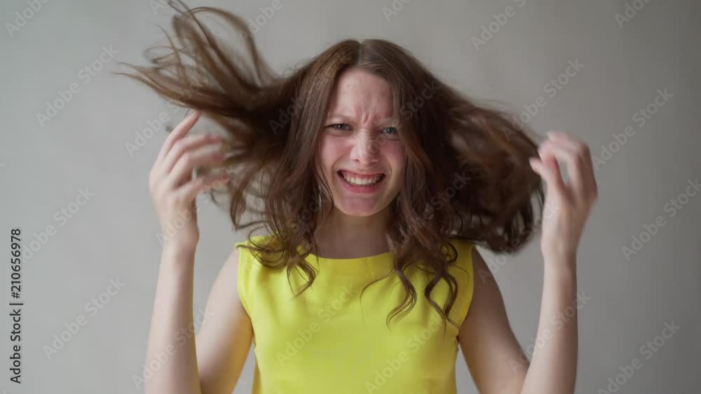 Angry woman yelling, caucasian girl with long hair screaming with rage Angry woman yelling, caucasian girl with long hair screaming with rage