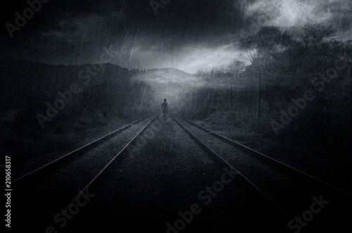 mysterious fantasy scene with ghostly shadow on railroad tracks