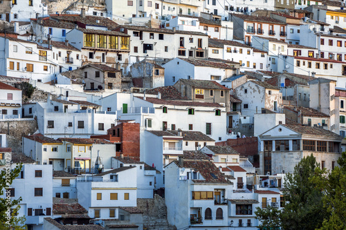 Fototapeta Naklejka Na Ścianę i Meble -  Houses and roofs next to mountain limestone, view to the mountains of the river Jucar, take in Alcala del Jucar, Albacete province, Spain