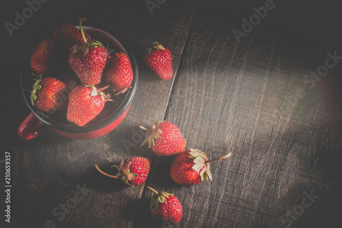 Strawberries in a cup on the table photo