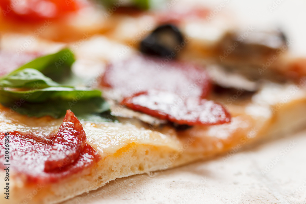 A hot pizza slice with dripping melted cheese. Isolated on white.