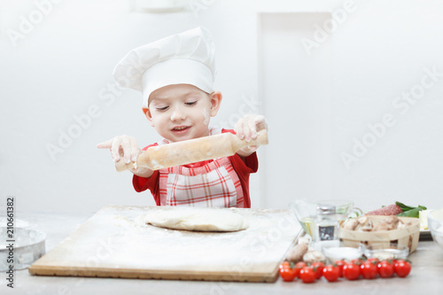 Boy with chef hat preparing...