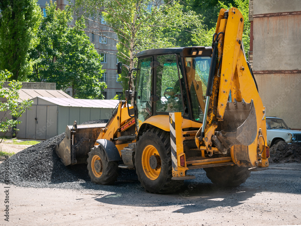 Buldozer Making and constructing a new asphalt road near the civil building. Concepts of improvement of the territory of buildings. Housing and utilities concepts