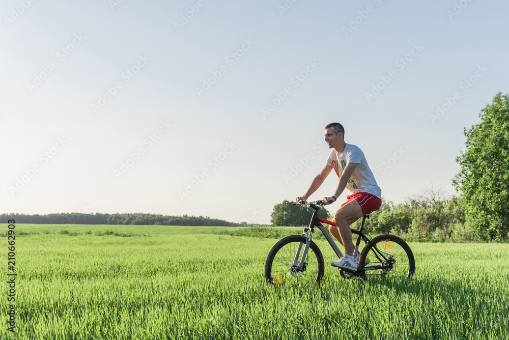 The man is riding a bicycle