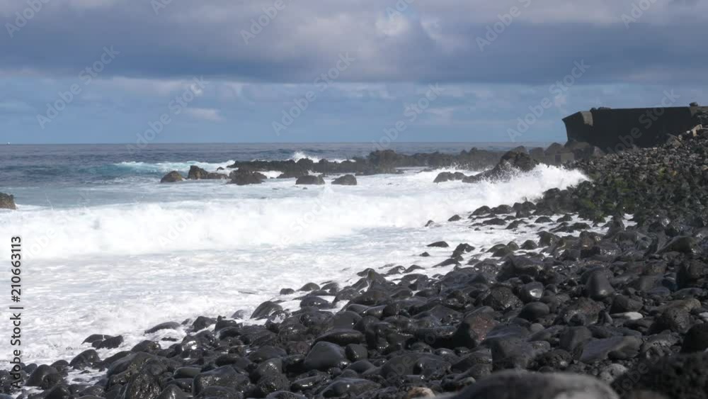 Scenic waves of Athlantic Ocean slow motion rushing to a black pebble shore of Tenerife Scenic waves of Athlantic Ocean slow motion rushing to a black pebble shore of Tenerife