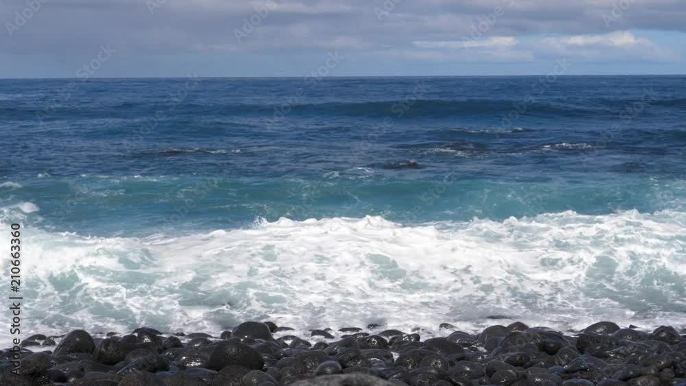 Scenic waves of Athlantic Ocean slow motion rushing to a black pebble shore of Tenerife Scenic waves of Athlantic Ocean slow motion rushing to a black pebble shore of Tenerife