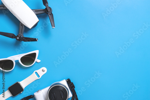Hi tech travel gadget and accessories on blue copy space photo