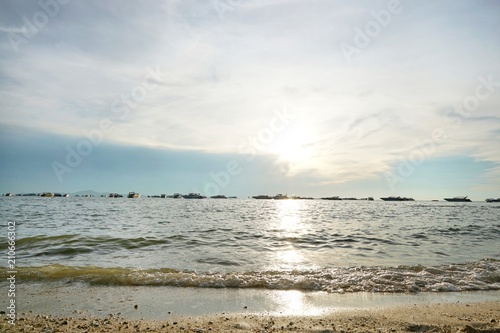 Morning on sea  Beautiful nature blue sky with clouds. Colorful sky as a background. Soft wave of the sea on the sandy beach at  Cha-am beach  Thailand. Space for text in template. Travel concept.