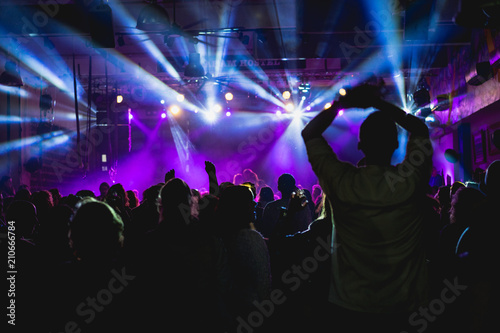 Tel Aviv, Israel February 23, 2018: White lights with a purple background at a concert with people cheering