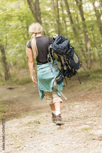 Female Backpacker walking away Carrying her backpack