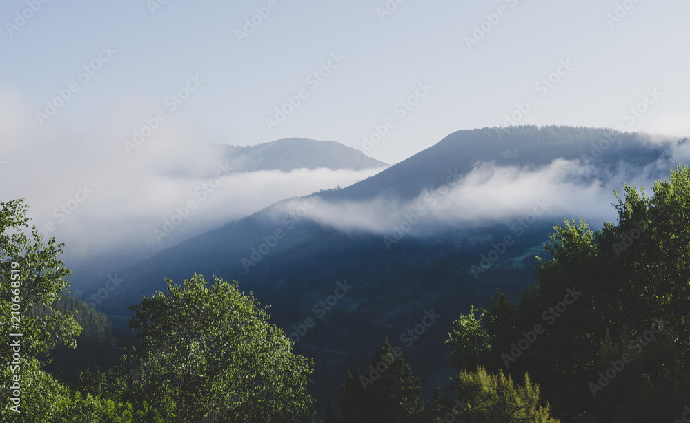 Mysterious mountain landscape with fog banks.