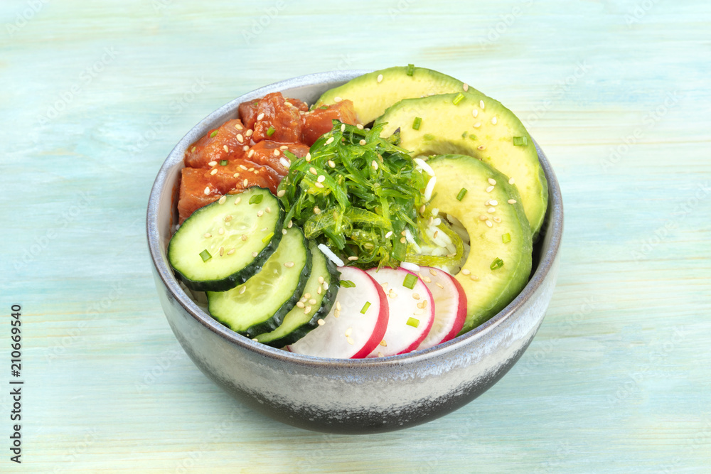 Hawaiian tuna poke salad with wakame, avocado, cucumbers, radish Hawaiian tuna poke salad with wakame, avocado, cucumbers, radish