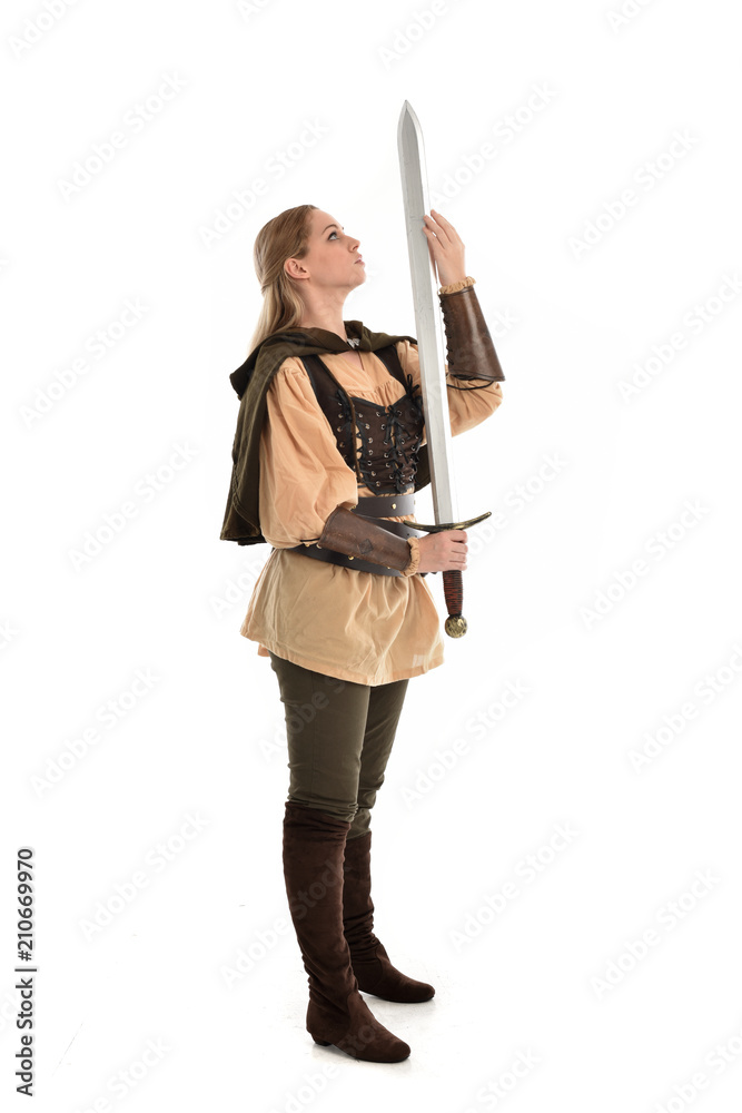 full length portrait of girl wearing brown medieval costume,. standing pose, isolated on white studio background. full length portrait of girl wearing brown medieval costume,. standing pose, isolated on white studio background.