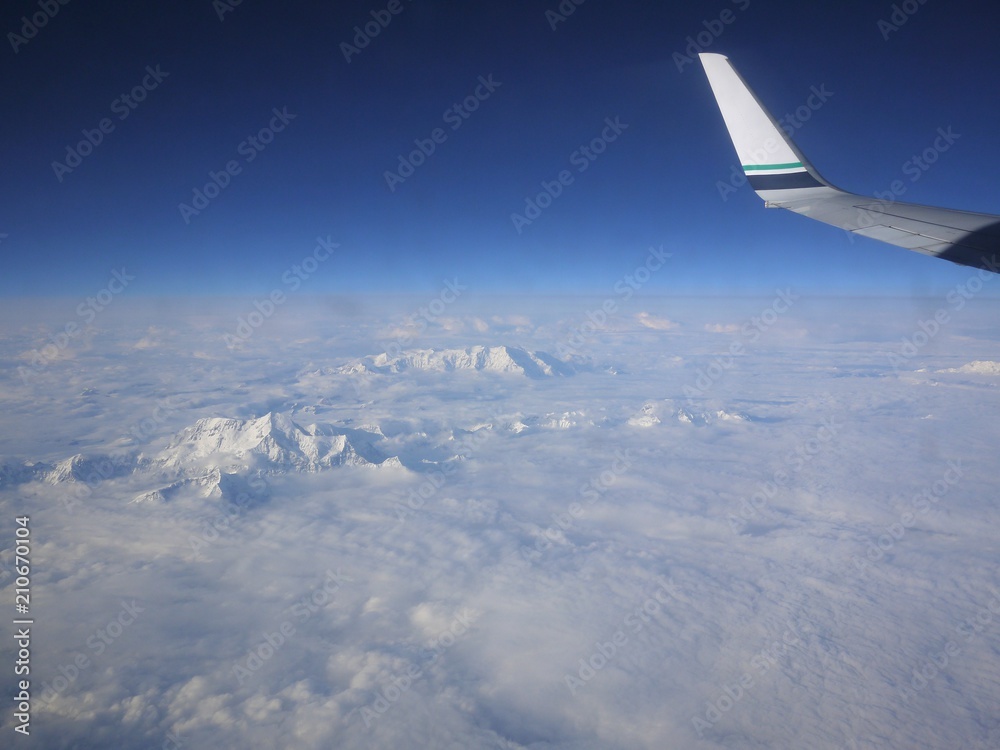 Flying over the mountains with snow in Alaska Flying over the mountains with snow in Alaska