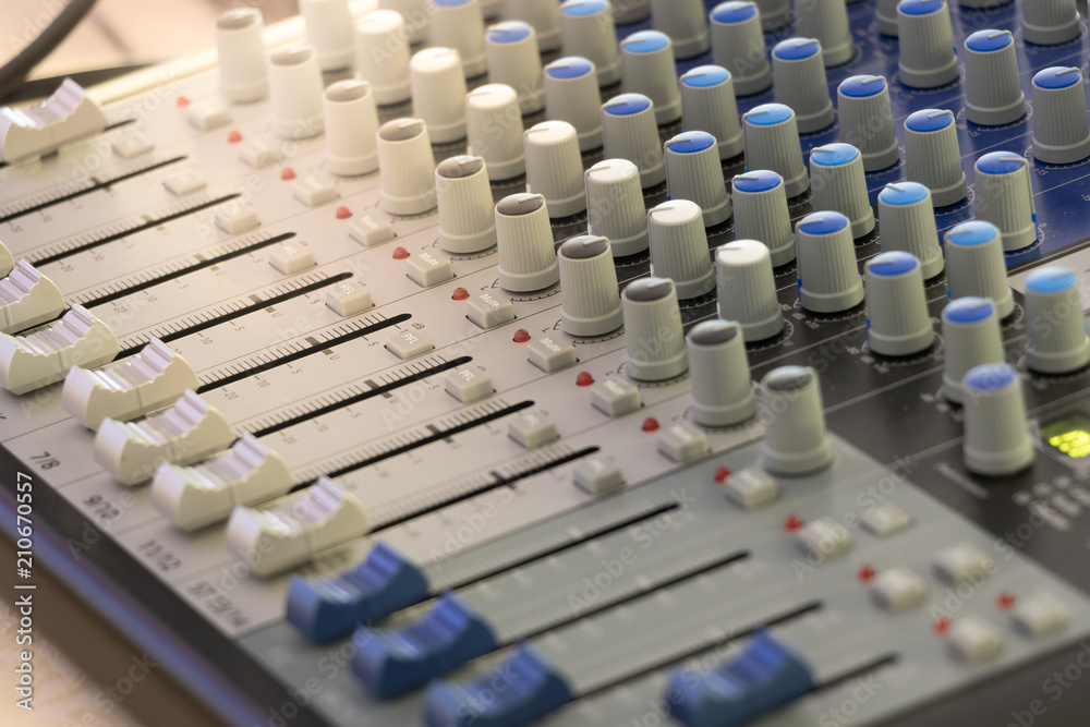 Fototapeta premium Detail with adjusting knobs on a professional audio mixer and music equipment for sound mixer control, electronic device