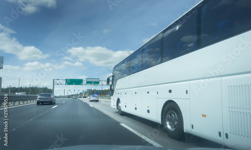 Modern White Passenger Bus on the highway, City Tourist Bus Transportation Vehicle, Modern and Comfortable Coach, Traveling by Bus photo