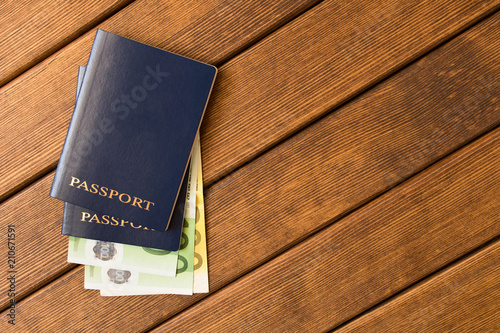 Passports with Euro banknotes on a wooden table . Travel readiness concept. Empty text space