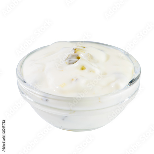 White garlic and herbs sauce in a small glass bowl isolated on b