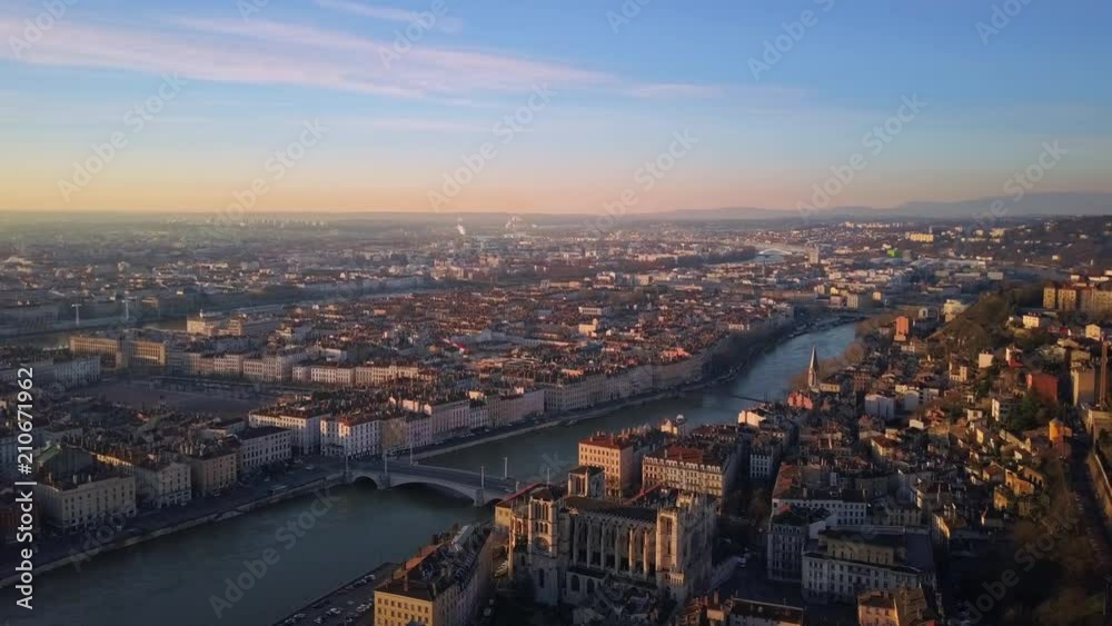 lyon city aerial view at sunrise flying from center to notre dame basilica