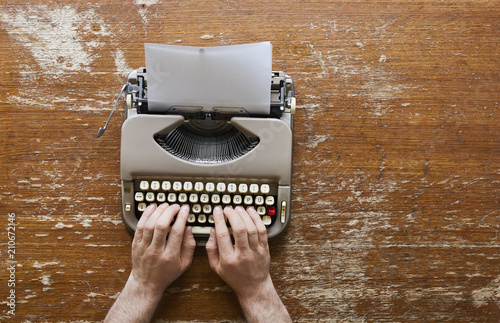 writing on vintage typwriter two hands on keyboard