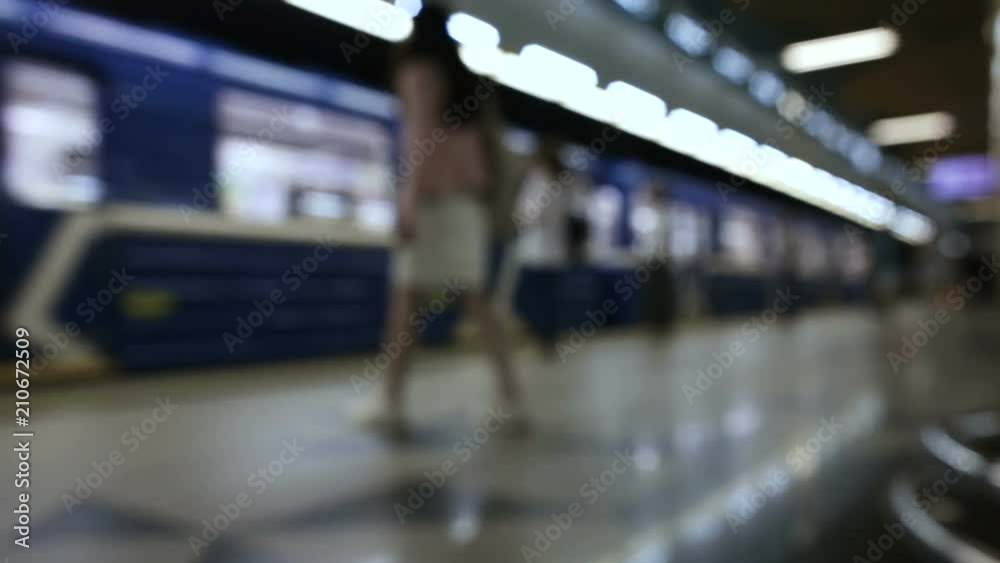 People are waiting for the train at metro station and boarding a carriages People are waiting for the train at metro station and boarding a carriages