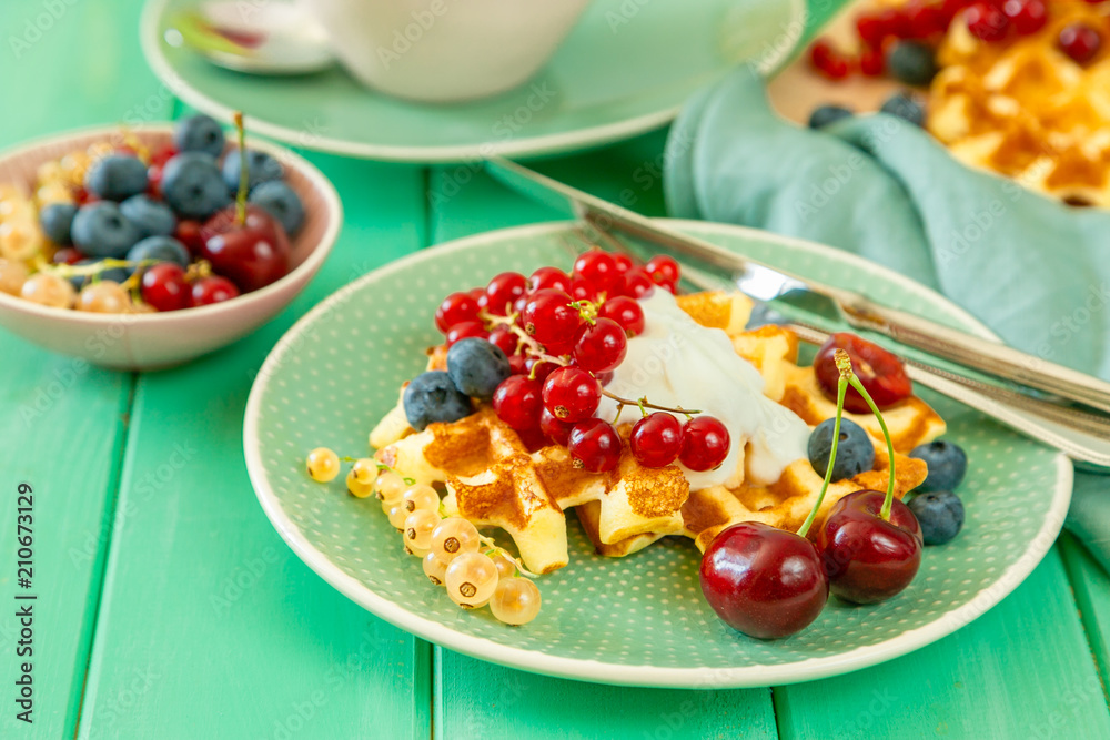Breakfast with waffles, wipped cream, berries and granola Breakfast with waffles, wipped cream, berries and granola