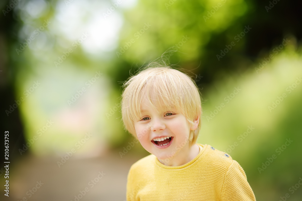 Cheerful little boy enjoying warm summer day Cheerful little boy enjoying warm summer day