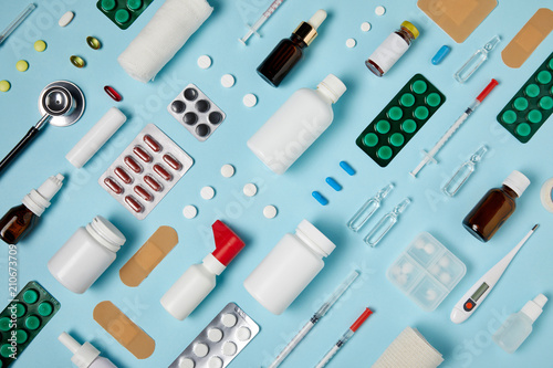 full frame shot of composed various medical supplies on blue surface photo