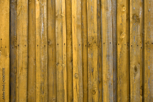 Yellow wooden fence background. Rustic view.