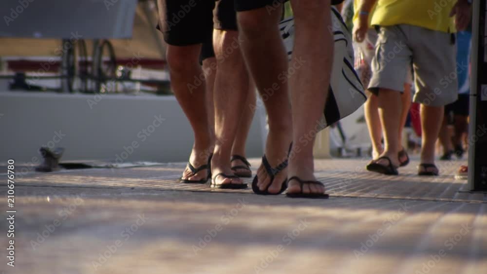 A worm's eye view of people's feet as they walk in the pier. A worm's eye view of people's feet as they walk in the pier.