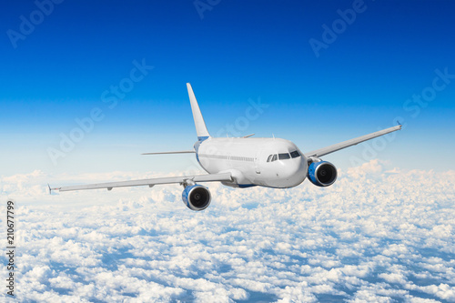Aircraft flies height, flight level high in the sky above the clouds blue sky.
