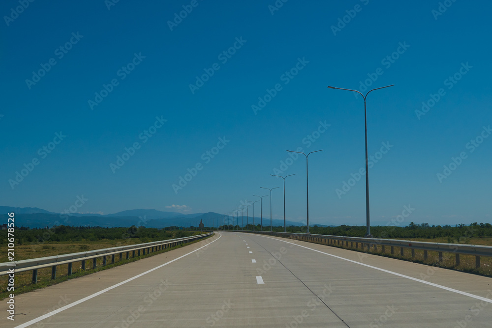 Road trip view from the car asphalt and blue sky