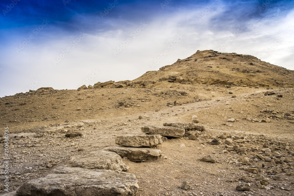 Desert ground and stones with dramatic skies and no people