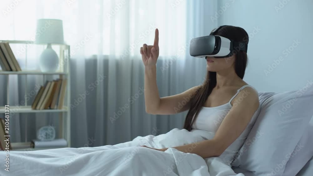 Girl surfing Internet using virtual reality headset, computer technology era