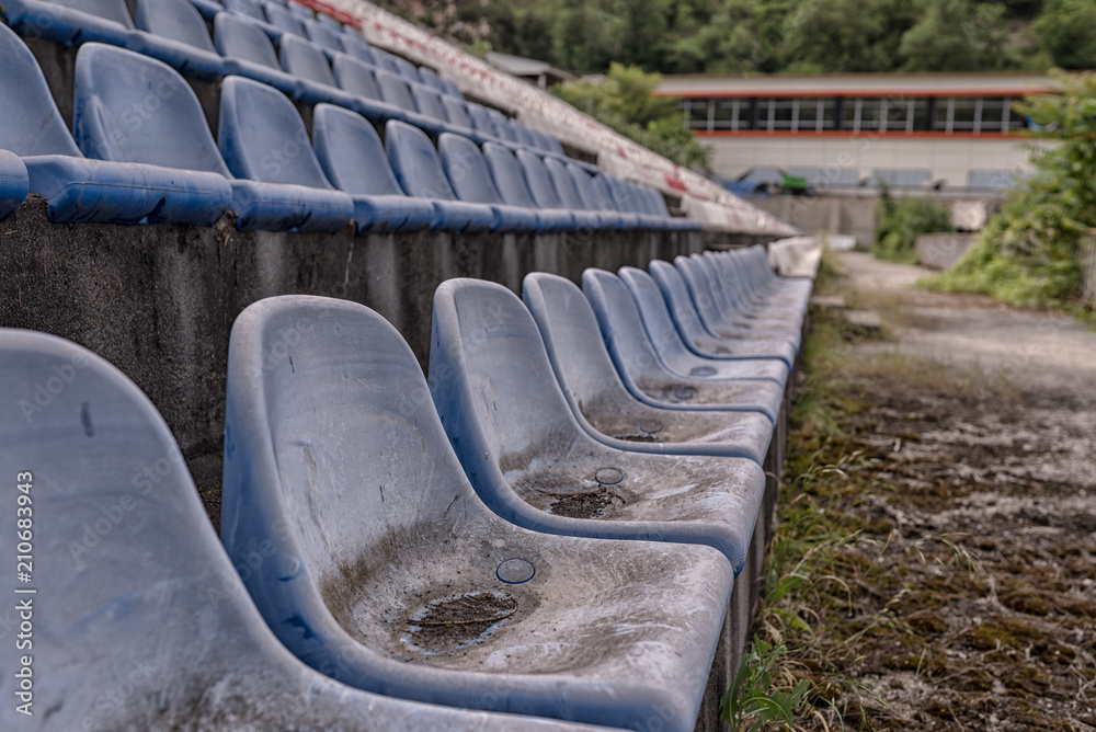 Fototapeta premium Vintage Stadium Chairs old time not used with dust blue color