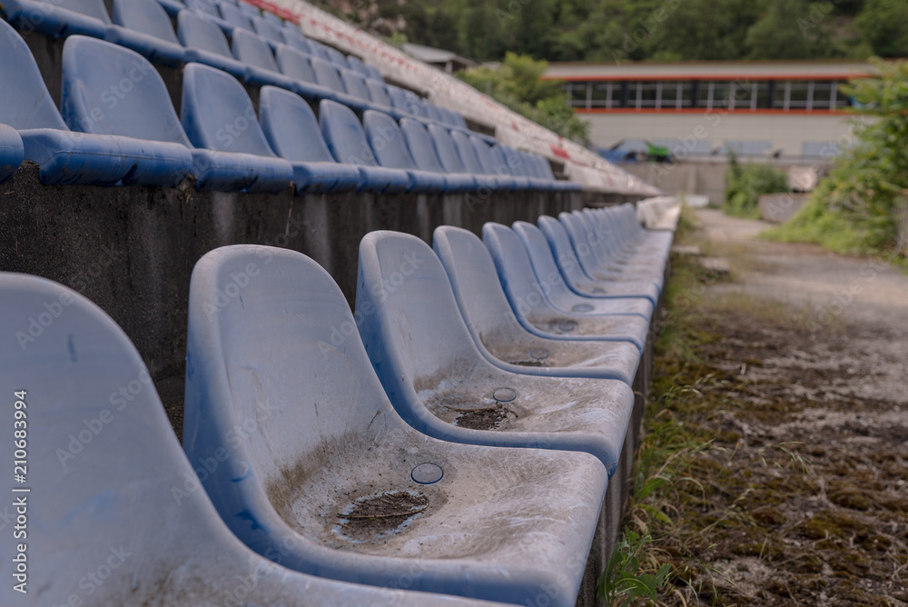 Fototapeta premium Vintage Stadium Chairs old time not used with dust blue color
