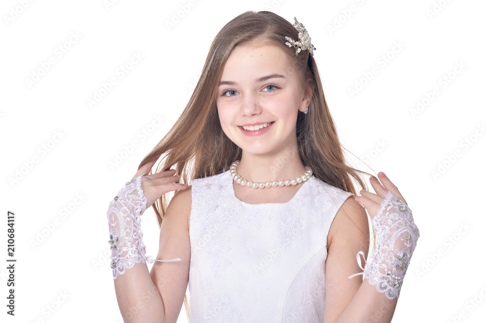 Happy little girl in beautiful white dress posing