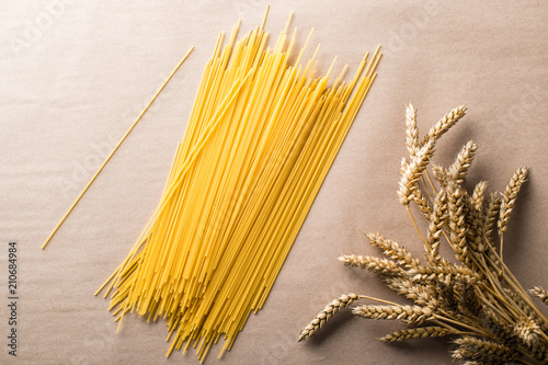 Italian food. Still life with spaghetti pasta and ears of wheat 