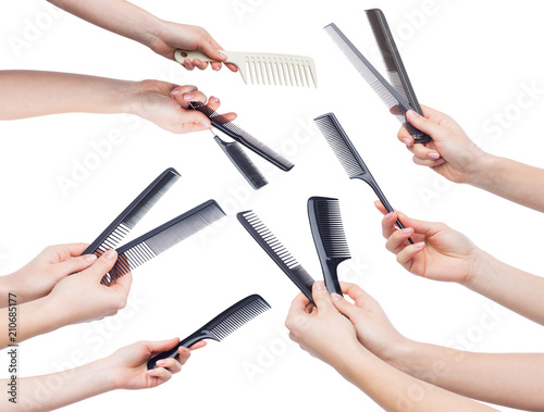 Female hands holding various combs isolated on white