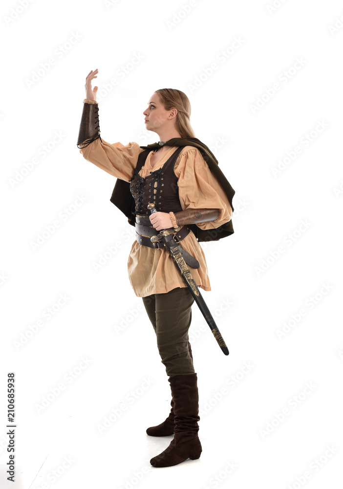 full length portrait of girl wearing brown medieval costume,. standing pose, isolated on white studio background. full length portrait of girl wearing brown medieval costume,. standing pose, isolated on white studio background.