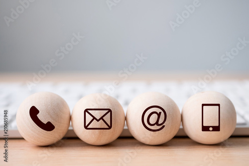 Wood sphere symbol telephone, mail, address and mobile phone. Website page contact us or e-mail marketing concept photo