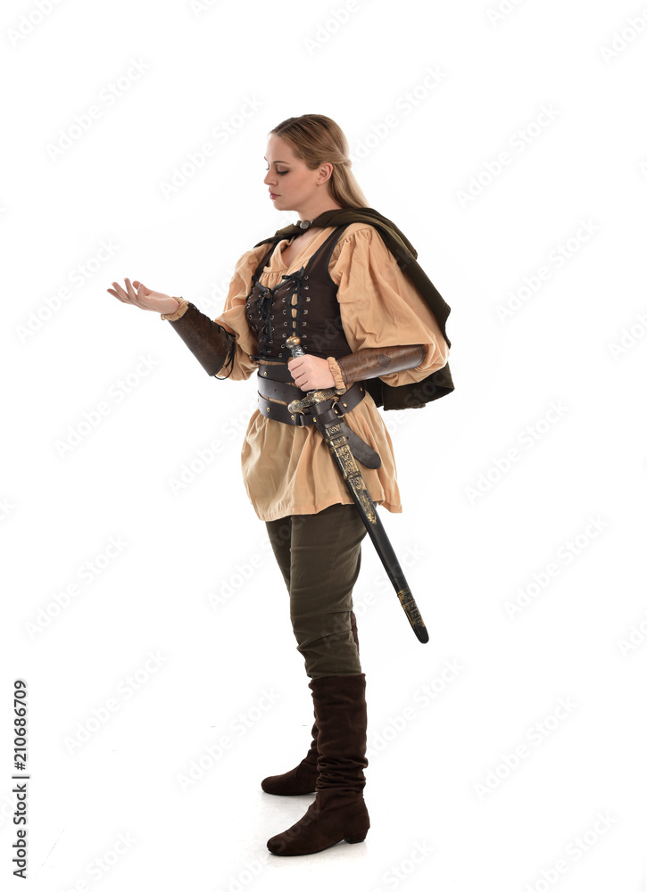 full length portrait of girl wearing brown medieval costume,. standing pose, isolated on white studio background. full length portrait of girl wearing brown medieval costume,. standing pose, isolated on white studio background.