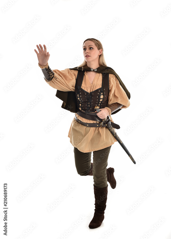 full length portrait of girl wearing brown medieval costume,. standing pose, isolated on white studio background. full length portrait of girl wearing brown medieval costume,. standing pose, isolated on white studio background.