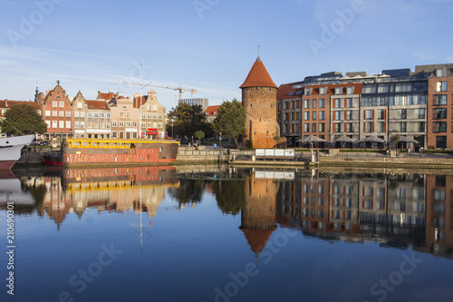 Old houses on the promenade of the river in Gdansk at dawn. Poland