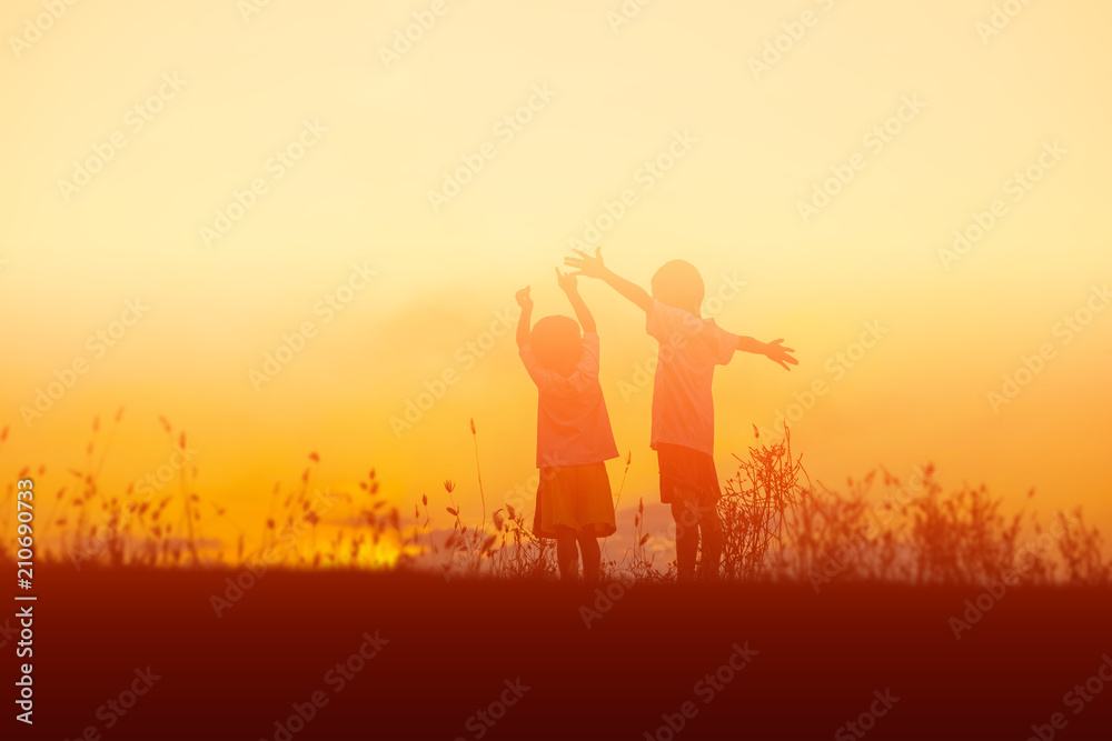 silhouette of a happy children and happy time sunset silhouette of a happy children and happy time sunset