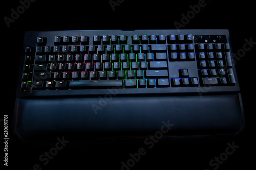 colorful lights mechanical buttons keyboard , gaming gear . modern black design . gamer hardware concept . 