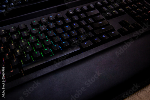 colorful lights mechanical buttons keyboard , gaming gear . modern black design . gamer hardware concept . 