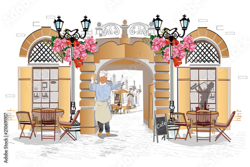 Fashion people in the street cafe. Street cafe with flowers in the old city.