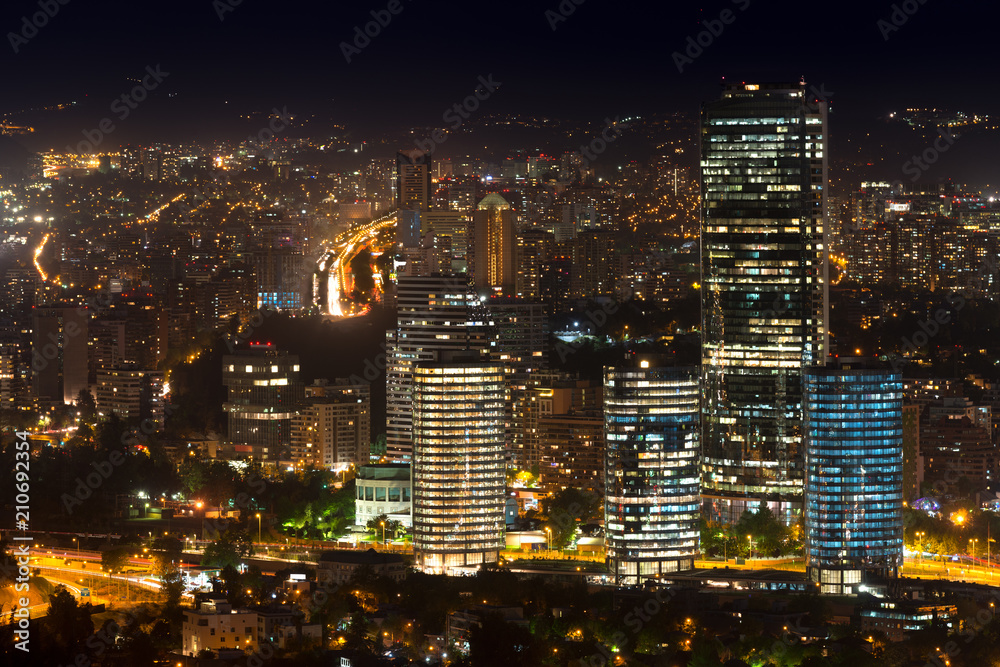 Panoramic view of Providencia, Las Condes and Vitacura districts in Santiago de Chile at night.